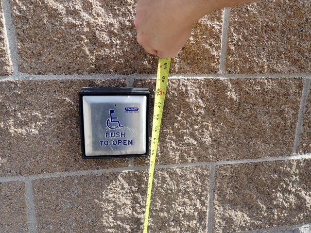 Tape measure used to measure the height of a push button