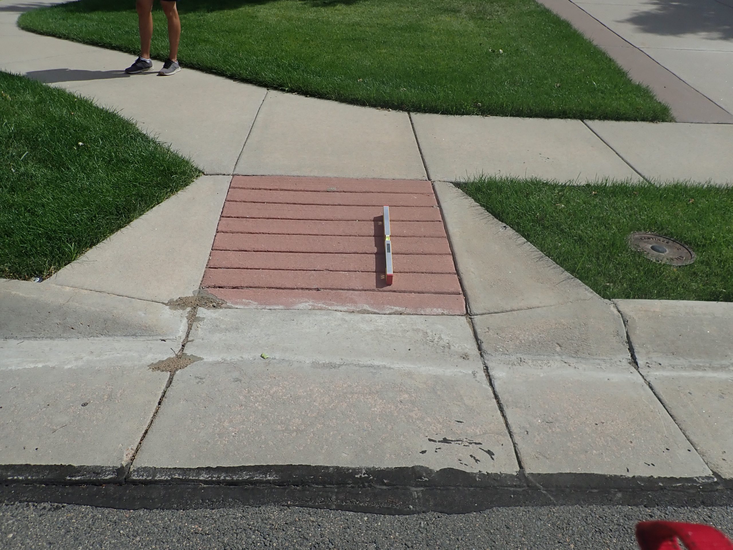 Level measuring the slope of a curb ramp